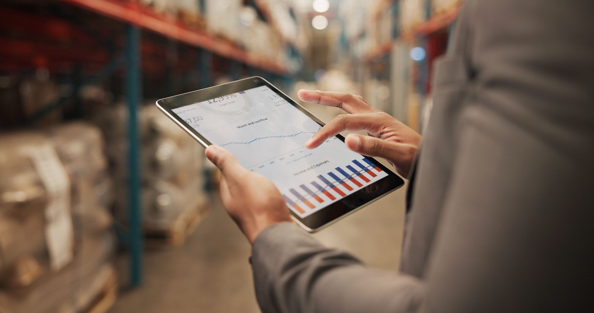 Person, hands or logistics with tablet screen for analytics, graph or chart data at storage warehouse. Closeup, distributor or analyst with technology for inventory expenses, income or stock cashflow